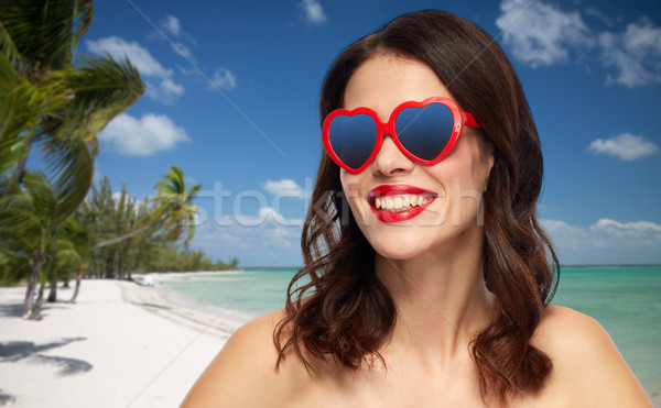 woman with red lipstick and heart shaped shades Stock photo © dolgachov