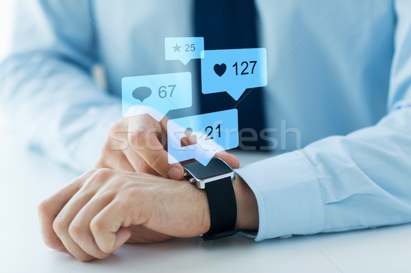 hands with smart watch and social media icons Stock photo © dolgachov