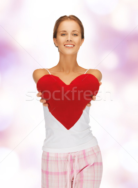 happy and smiling woman with heart-shaped pillow Stock photo © dolgachov