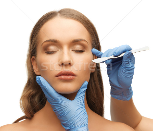 woman face and beautician hands Stock photo © dolgachov
