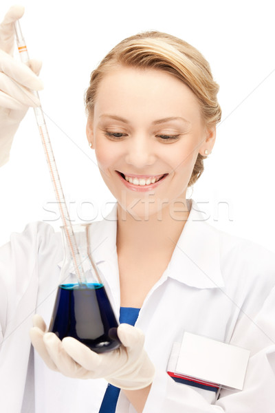 female chemist holding bulb with chemicals Stock photo © dolgachov