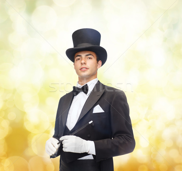 magician in top hat with magic wand showing trick Stock photo © dolgachov