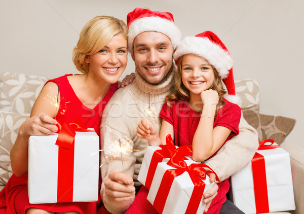 smiling family holding gift boxes and sparkles Stock photo © dolgachov