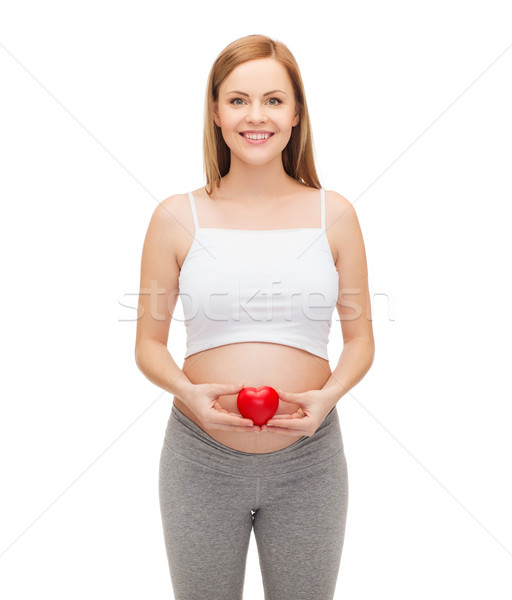 Stock photo: happy future mother holding small red heart