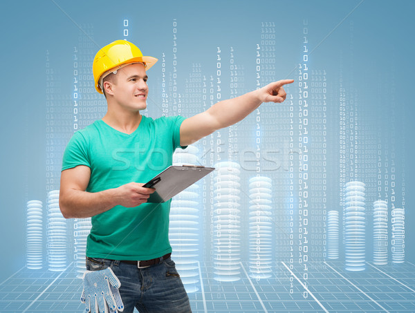 [[stock_photo]]: Souriant · homme · casque · presse-papiers · réparation · construction