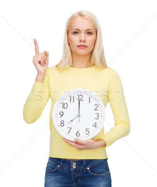 student with wall clock and finger up Stock photo © dolgachov