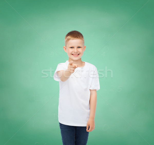 Stock photo: little boy in white t-shirt pointing his finger