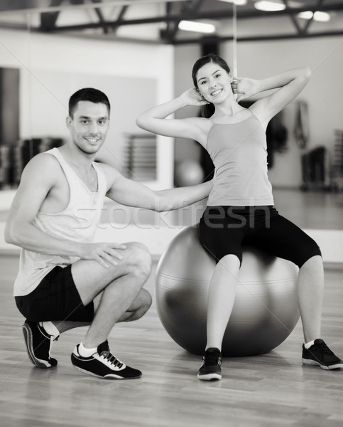 male trainer with woman doing crunches on the ball Stock photo © dolgachov