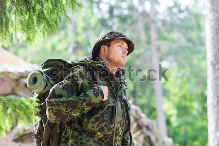 close up of soldier or hunter with gun in forest Stock photo © dolgachov