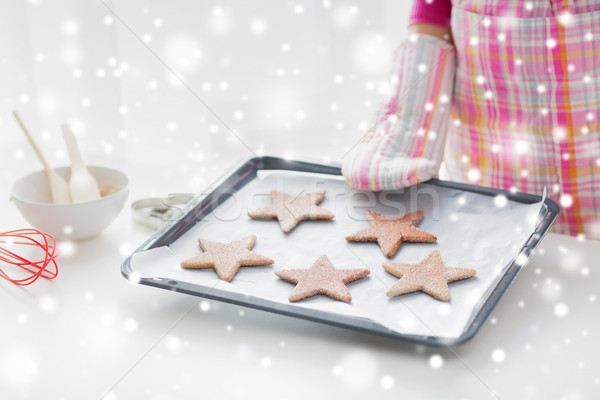 close up of woman with cookies on oven tray Stock photo © dolgachov