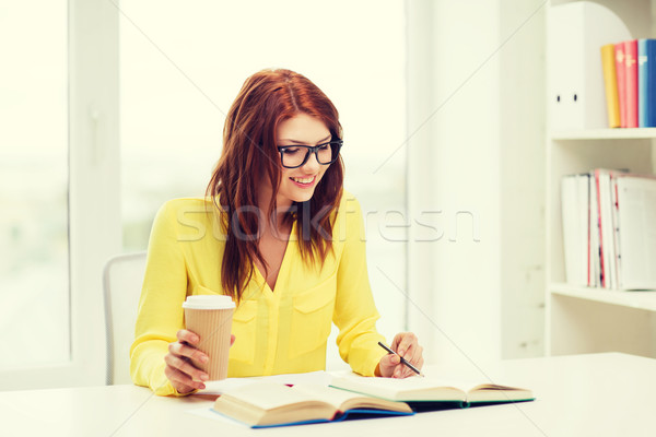 smiling student girl reading books in library Stock photo © dolgachov