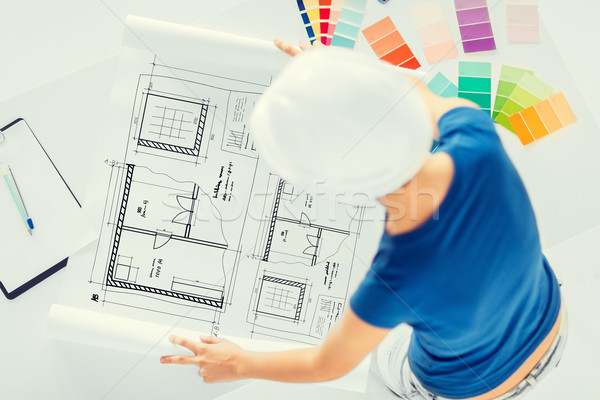 Stock photo: woman with color samples and blueprint
