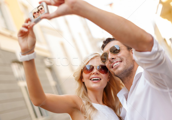 travelling couple taking photo picture with camera Stock photo © dolgachov