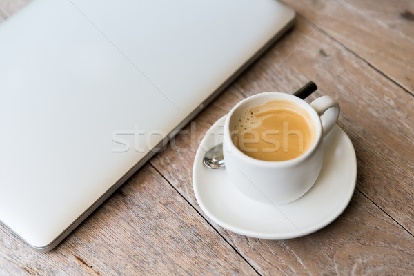 close up of laptop and coffee cup on office table Stock photo © dolgachov
