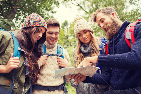 group of smiling friends with backpacks hiking Stock photo © dolgachov