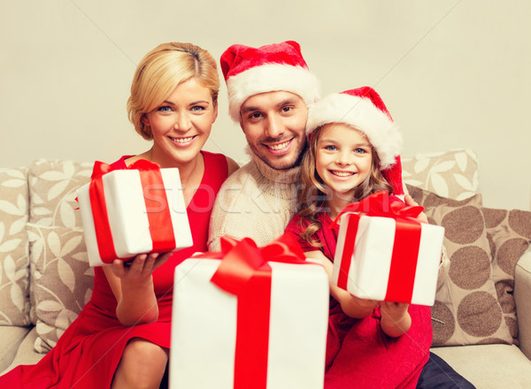 smiling family giving many gift boxes Stock photo © dolgachov