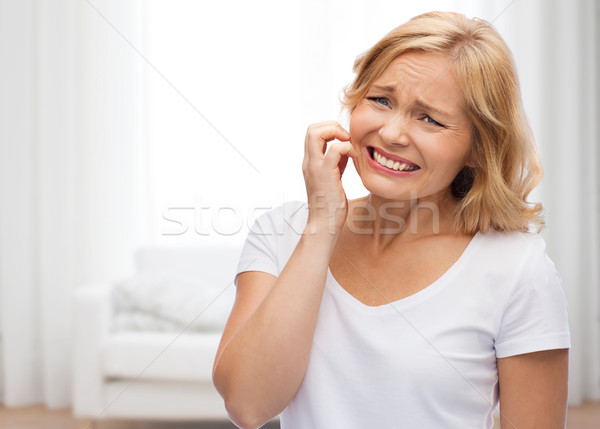 Boldogtalan nő szenvedés arc hüvelyk emberek Stock fotó © dolgachov