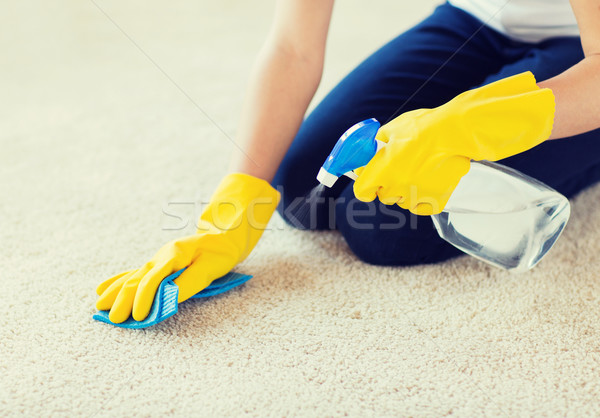 close up of woman with cloth cleaning carpet Stock photo © dolgachov