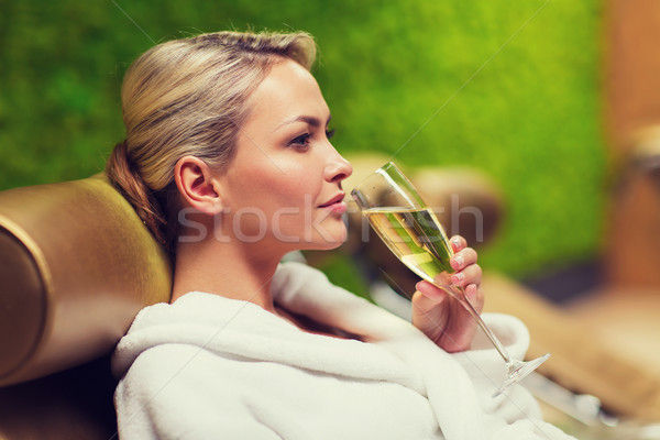 beautiful young woman drinking champagne at spa Stock photo © dolgachov