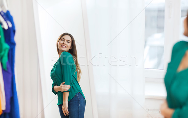 Stock photo: happy woman posing at mirror in home wardrobe