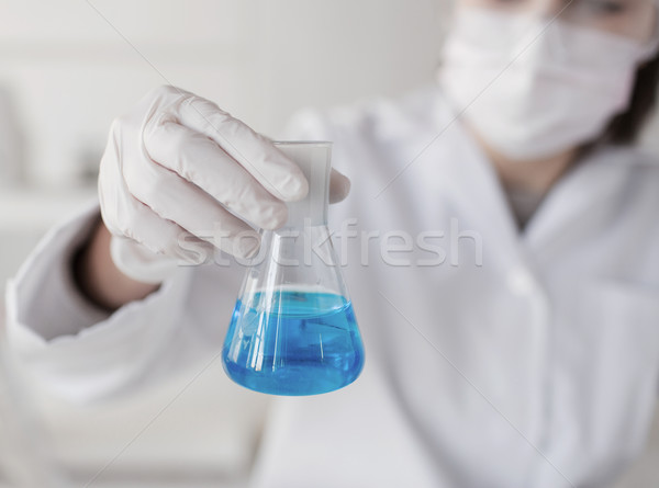 close up of woman with flask making test in lab Stock photo © dolgachov