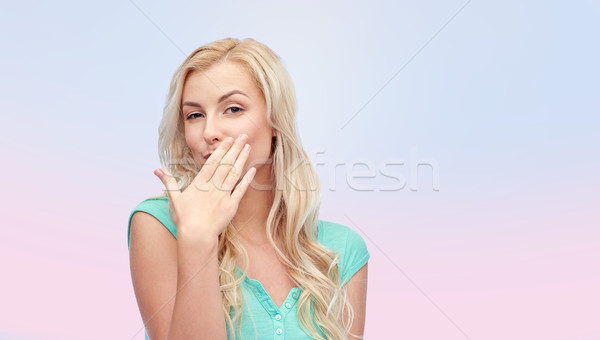 smiling young woman or teen girl covering mouth Stock photo © dolgachov