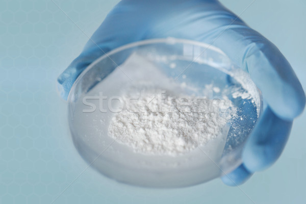 close up of scientist hands holding petri dish Stock photo © dolgachov