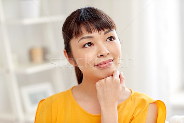 happy asian young dreaming woman face at home Stock photo © dolgachov