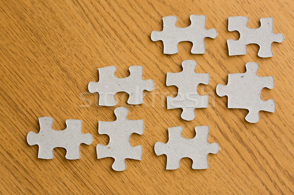 close up of puzzle pieces on wooden surface Stock photo © dolgachov
