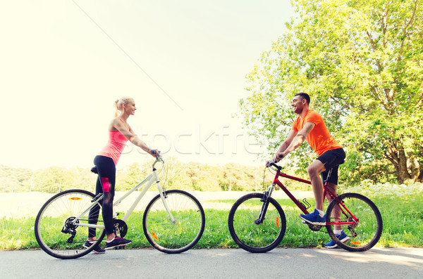 happy couple riding bicycle outdoors Stock photo © dolgachov