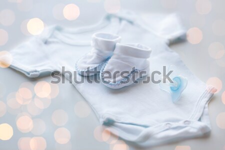 close up of baby mittens and soothers for twins Stock photo © dolgachov