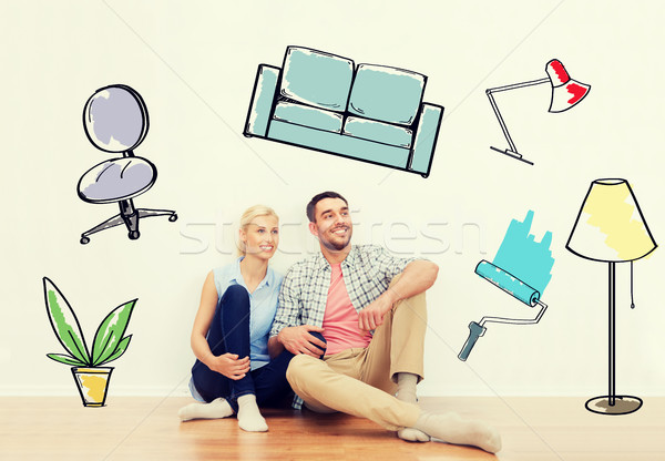 happy couple of man and woman moving to new home Stock photo © dolgachov