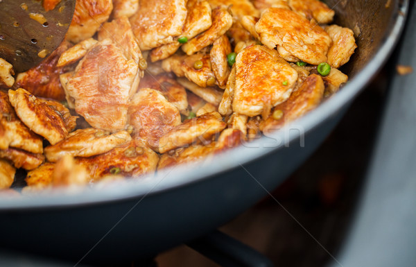 close up of meat in wok pan at street market Stock photo © dolgachov