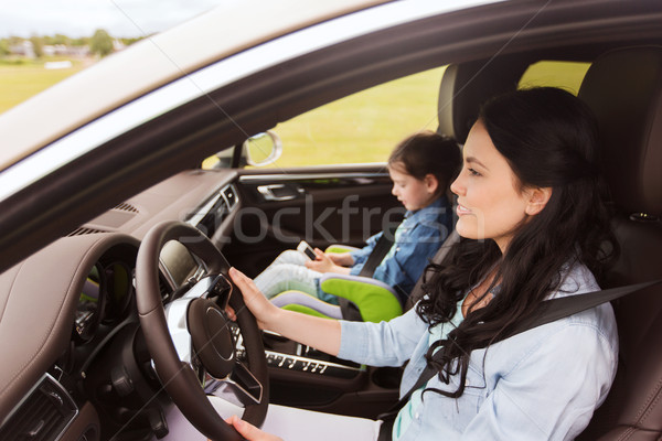 happy woman with little child driving in car Stock photo © dolgachov