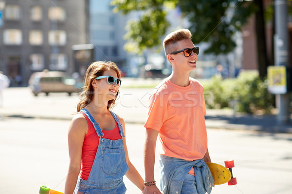 teenage couple with skateboards on city street Stock photo © dolgachov