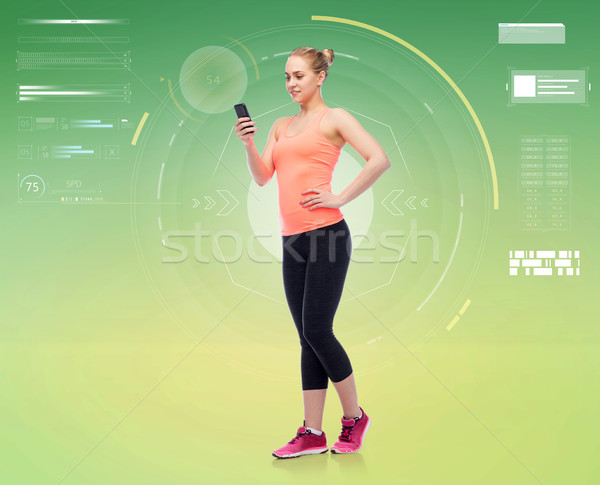 happy smiling sportive young woman with smartphone Stock photo © dolgachov