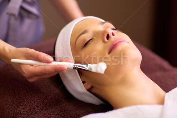 beautician applying facial mask to woman at spa Stock photo © dolgachov