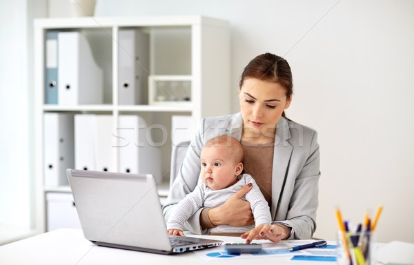 businesswoman with baby working at office Stock photo © dolgachov