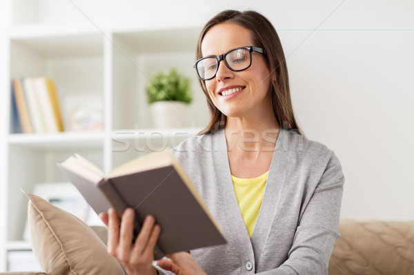 Jeune femme verres lecture livre maison loisirs [[stock_photo]] © dolgachov