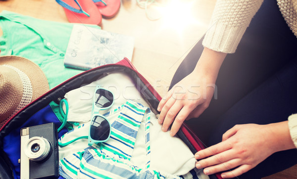 Stock photo: close up of woman packing travel bag for vacation