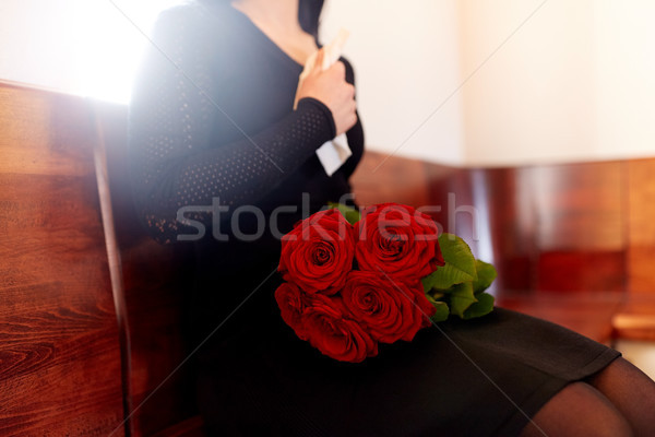 close up of woman with roses at funeral in church Stock photo © dolgachov