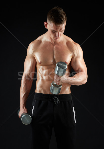 man with dumbbells exercising Stock photo © dolgachov