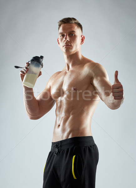 bodybuilder with protein shake showing thumbs up Stock photo © dolgachov