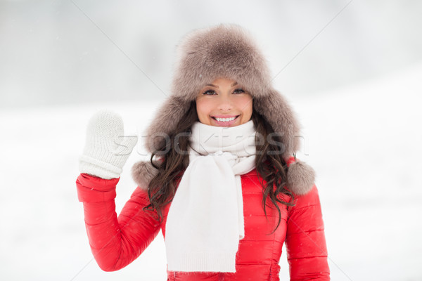 happy woman in winter fur hat waving hand outdoors Stock photo © dolgachov