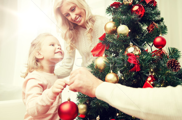 happy family decorating christmas tree at home Stock photo © dolgachov