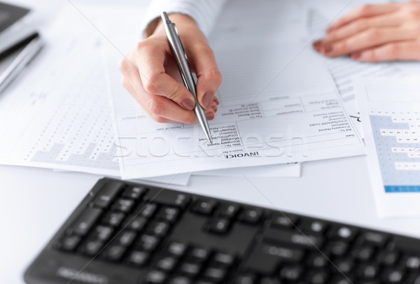 Stock photo: woman hand filling in invoice paper