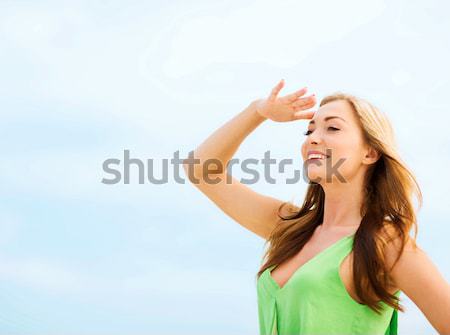 girl looking for direction on the beach Stock photo © dolgachov
