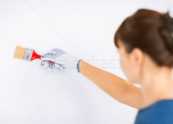 woman with paintbrush colouring the wall Stock photo © dolgachov