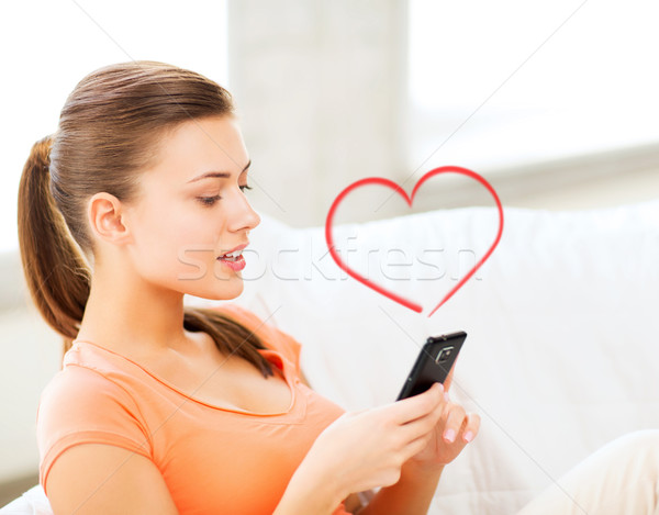 Stock photo: woman with smartphone at home