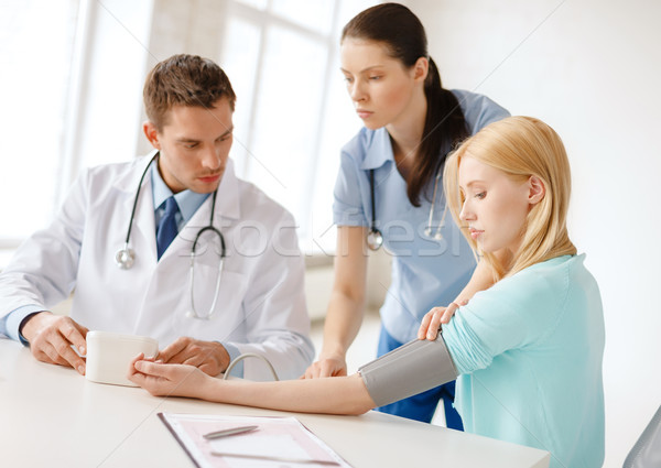 male doctor, female nurse and patient in hospital Stock photo © dolgachov
